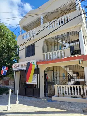 a building with a flag in front of it at Dona Beba Guesthouse in La Caleta
