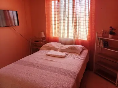 a bedroom with a bed with two towels on it at Dona Beba Guesthouse in La Caleta