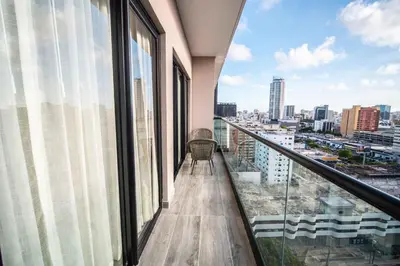 a balcony in a building with a view of the city at Aston Rubi City Suites in Santo Domingo
