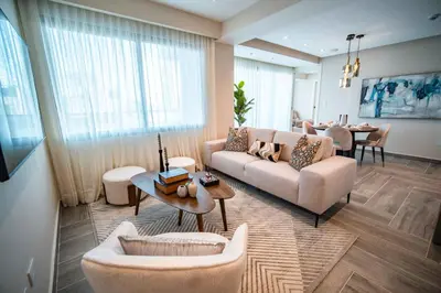 a living room with a couch and chairs and a table at Aston Rubi City Suites in Santo Domingo