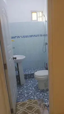 a bathroom with a toilet and a sink at Residencial A&H in Boca Chica