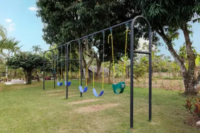 a group of swings in a park at Rancho Don Pedro in Bonao