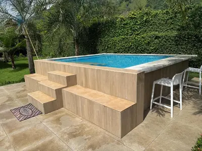 a swimming pool with a table and a stool at Rancho Don Pedro in Bonao