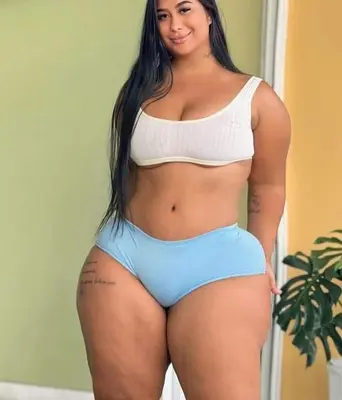a woman in a white crop top and blue shorts at Loteria florida in Higuey