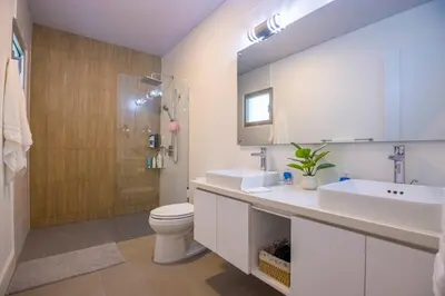 a bathroom with a sink and a toilet and a shower at Perla Marina Beachside Apartment in Bombita