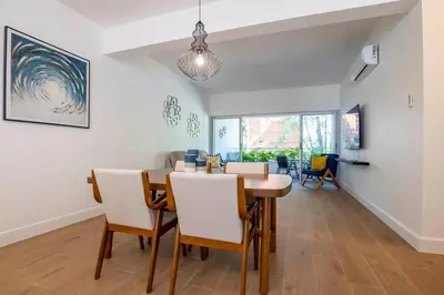 a dining room with a table and chairs at Perla Marina Beachside Apartment in Bombita