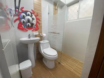 a small bathroom with a toilet and a sink at Beach Cabin Juan Dolio in Villas del Mar