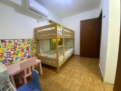 a room with bunk beds and a table and a desk at Beach Cabin Juan Dolio in Villas del Mar
