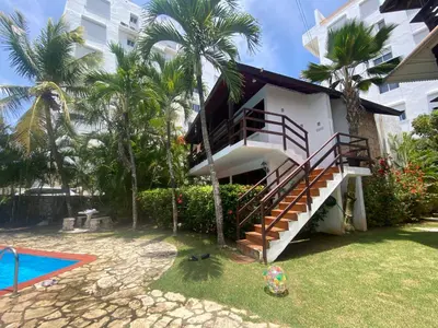a house with a staircase next to a swimming pool at Beach Cabin Juan Dolio in Villas del Mar