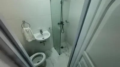 a bathroom with a shower and a toilet and a sink at Aparta Hotel Ana Julia in Sosúa