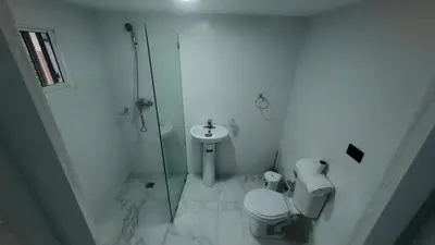 a bathroom with a shower and a toilet and a sink at Aparta Hotel Ana Julia in Sosúa