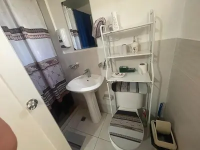 a small bathroom with a sink and a toilet at Apartamento en Edificio Palmares in La Romana