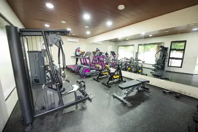 a gym with a bunch of tread machines in it at Blue Lux in Santiago de los Caballeros