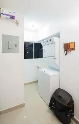 a white kitchen with a stove and a trash can at Blue Lux in Santiago de los Caballeros