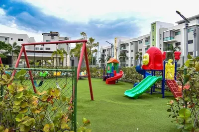 a playground with slides and a swing set at Blue Lux in Santiago de los Caballeros