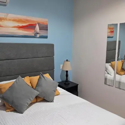 a bedroom with a bed and a painting on the wall at Flamingo Villa in Boca Paraiso in Boca Chica