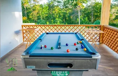a pool table in the middle of a room at Villa del Bosque, Vacacional Matua in La Piña
