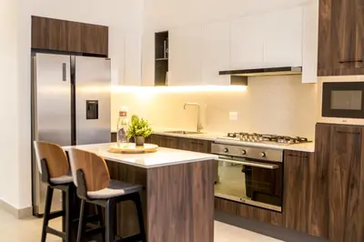 a kitchen with a island in the middle of a kitchen at Luxury Apartment Rooftop With Two Level and Infinitive Pool in Santiago de los Caballeros