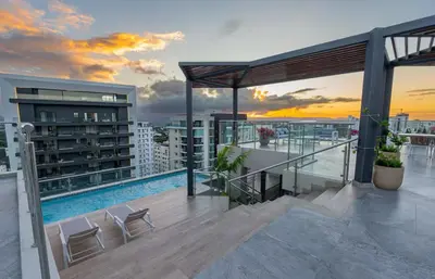 a balcony with a pool on top of a building at Luxury Apartment Rooftop With Two Level and Infinitive Pool in Santiago de los Caballeros