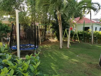 a playground in a yard with palm trees and a house at Apartment Rozarka Soficu El Edén Dominicus in La Laguna