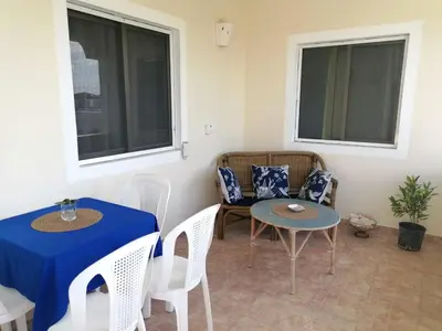 a room with a table and chairs and windows at Apartment Rozarka Soficu El Edén Dominicus in La Laguna