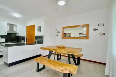a kitchen with a wooden table and a mirror at Oceanfront Apt W- Private Beach - Las Terrenas in El Limón
