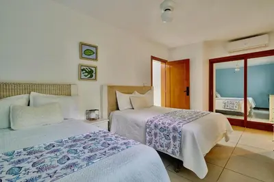 a hotel room with two beds and a window at Oceanfront Apt W- Private Beach - Las Terrenas in El Limón