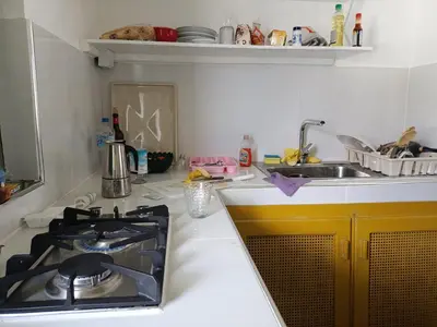 a kitchen counter with a stove and a sink at Cozy studio- centre - near beach in Las Terrenas
