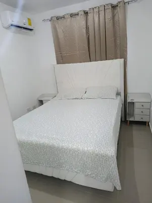 a bedroom with a white bed with a white comforter at El descanso perfecto in El Cruce