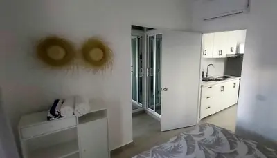 a kitchen with white walls and white cabinets at LA CASITA de Bayahibe in Bayahibe