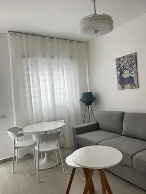 a living room with a couch and a table at LA CASITA de Bayahibe in Bayahibe