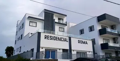a white building with a sign that reads residential roma at LA CASITA de Bayahibe in Bayahibe