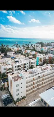 an aerial view of a city with buildings and the ocean at Apartment in Punta Cana, Beach & Confort in Punta Cana