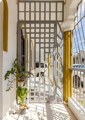an open gate to a balcony with plants at mini apartamento in Colorado