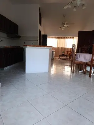 a kitchen with a white counter in the middle of a room at acuario residencial 2 in La Viva