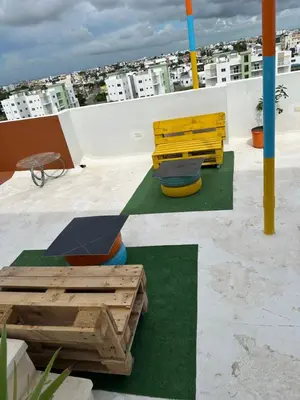 a bench and a table on top of a roof at Apartamento Santo Domingo este in Juan López