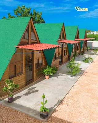 a row of houses with a green roof at VillaSol un descanso en pedernales in Pedernales