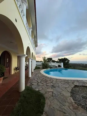 a building with a swimming pool next to a building at Desconéctate de la civilización in Nagua