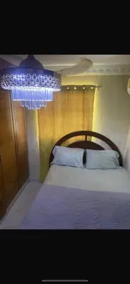 a bedroom with a bed with a wooden head board at The Garcias Village C with Jacuzzi ACNetflix in La Alianza