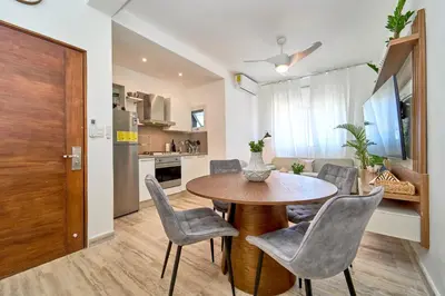 a kitchen and dining room with a table and chairs at Cana Brava Residences Rental Apartment Punta Cana in Punta Cana