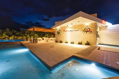 a resort with a swimming pool at night at Cana Brava Residences Rental Apartment Punta Cana in Punta Cana