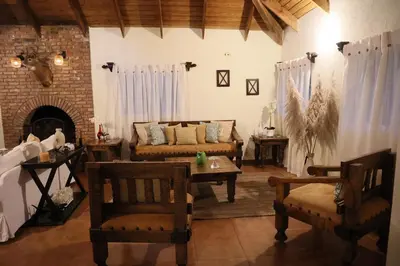 a living room with a couch and a table and chairs at Villa Claudia Constanza in Arroyo Frío