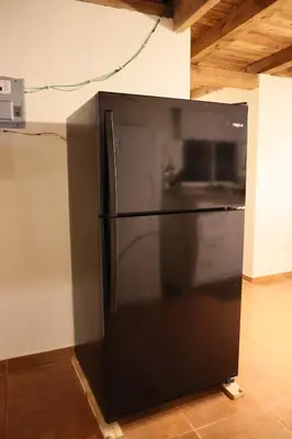 a black refrigerator sitting in the corner of a room at Villa Claudia Constanza in Arroyo Frío