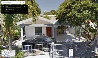 a house with a car parked in front of it at Your best escape in Dominican Republic!! in Santiago de los Caballeros