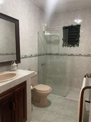 a bathroom with a shower and a toilet and a sink at Your best escape in Dominican Republic!! in Santiago de los Caballeros