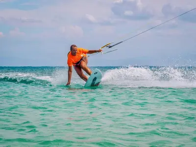 a man on a surfboard in the water at Buen Hombre Kite School with Accommodations in La Costa de Buen Hombre