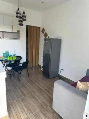 a kitchen and living room with a table and a refrigerator at Damaris Bed & Breakfast in Las Terrenas