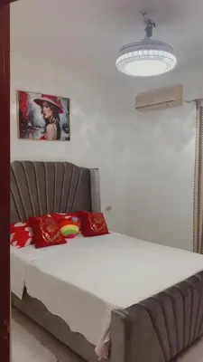 a bedroom with a bed with red pillows at Residence Oasis BocachiCa in Boca Chica