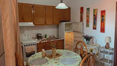 a kitchen with a table and a dining room at Residence Oasis BocachiCa in Boca Chica