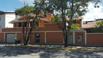 a motorcycle parked in front of a house at Residence Oasis BocachiCa in Boca Chica